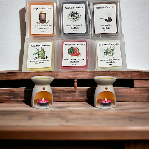 Various scented wax melts with two wax, melt burners in the foreground.