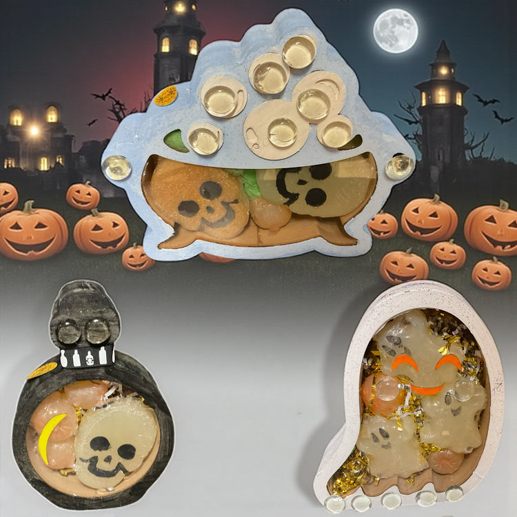 Hand decorated Halloween themed boxes filled with glycerin poured soap scented with lavender and or “vampire blood” with a Halloween themed background.