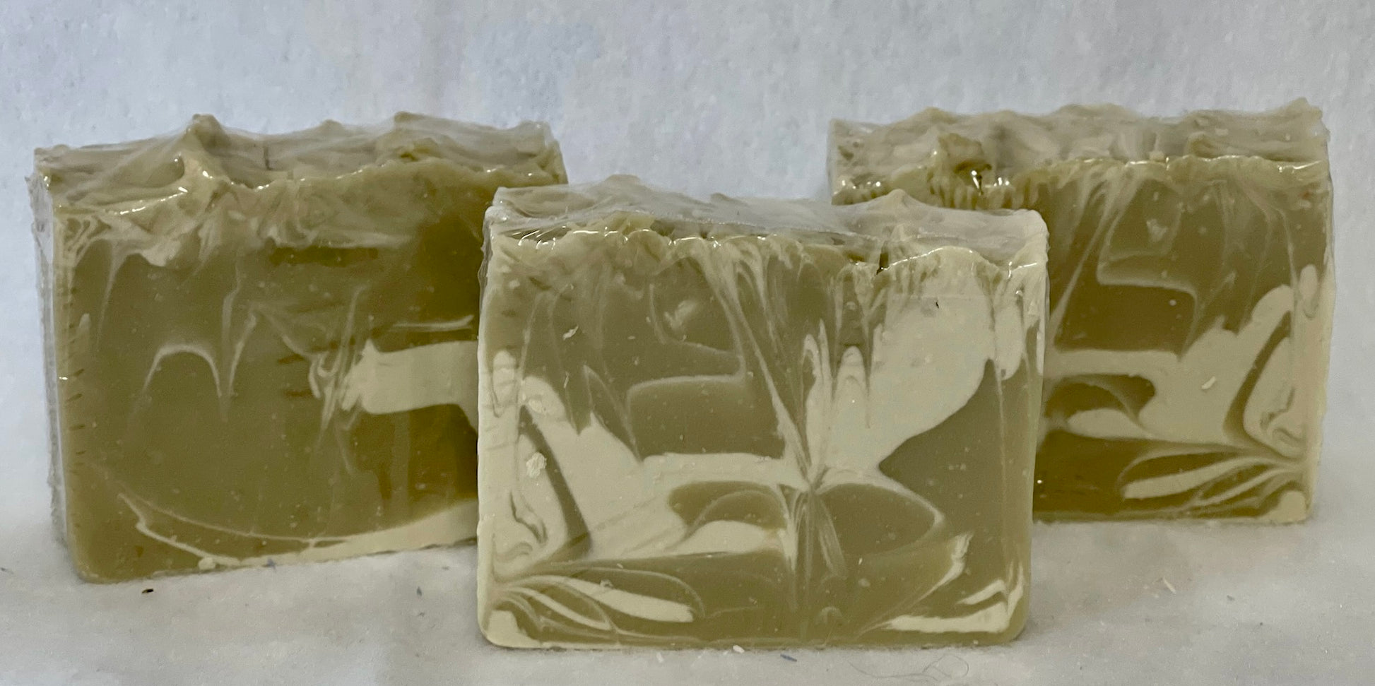 Moss green and white bars of forest mist soap