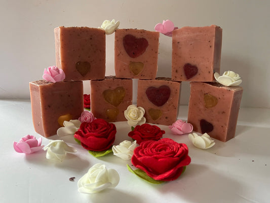 Photograph of rose scented soap with red and or gold heart embeds