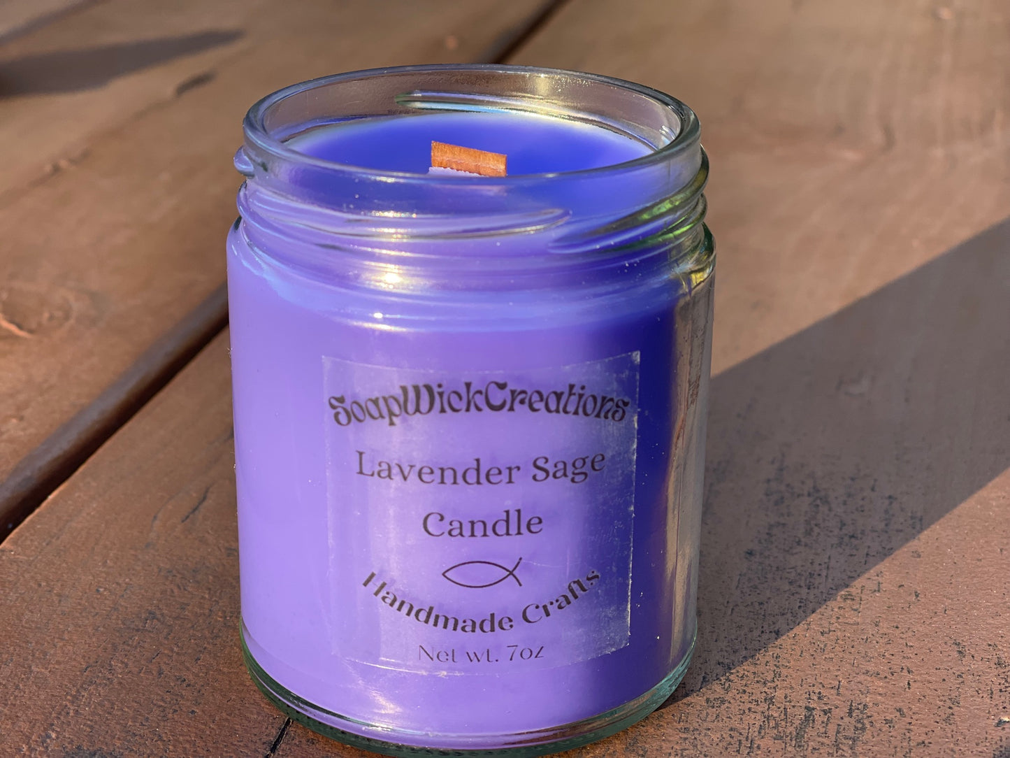 Photograph of a lavender colored candle with lavender Sage scent