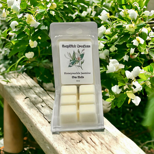 Photograph of white colored wax melts with Honeysuckle and Jasmine scenton a wooden bench with honeysuckle bushes in the background.