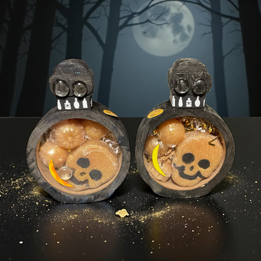 Hand decorated potion bottle boxes with Halloween theme containing glycerin poured “vampire blood“ scented soap with a Halloween themed background.