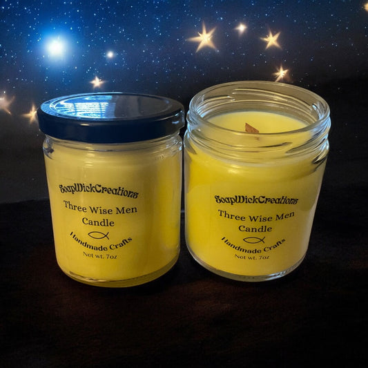 Two yellowish colored frankincense scented candles on a dark table with the night sky with stars in the background.