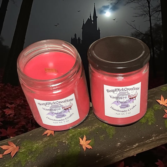 Two red and color, vampire blood scented candles in a gloomy forest, sitting on a moss covered rock with a castle and bats in the background.