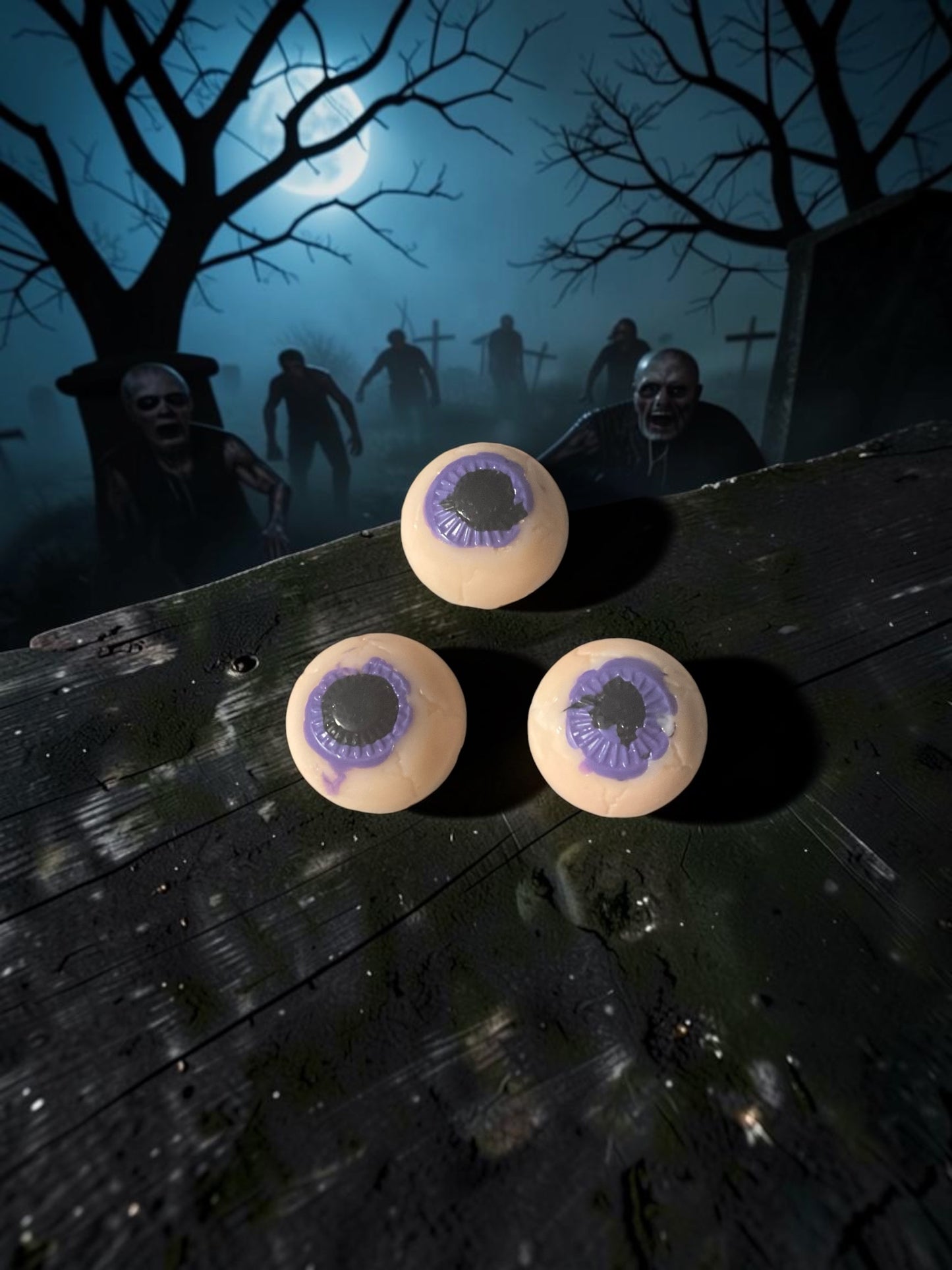 Three multicolored eyeball bar soaps. Sitting on a wooden table in a graveyard with zombies, approaching from the rare!