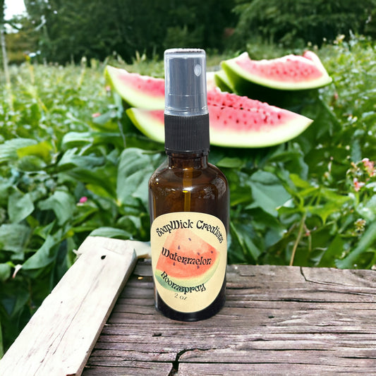 Photograph of a 2 ounce spray bottle containing watermelon  scented fragrance with freshly cut watermelons  and a watermelon patch in the background.