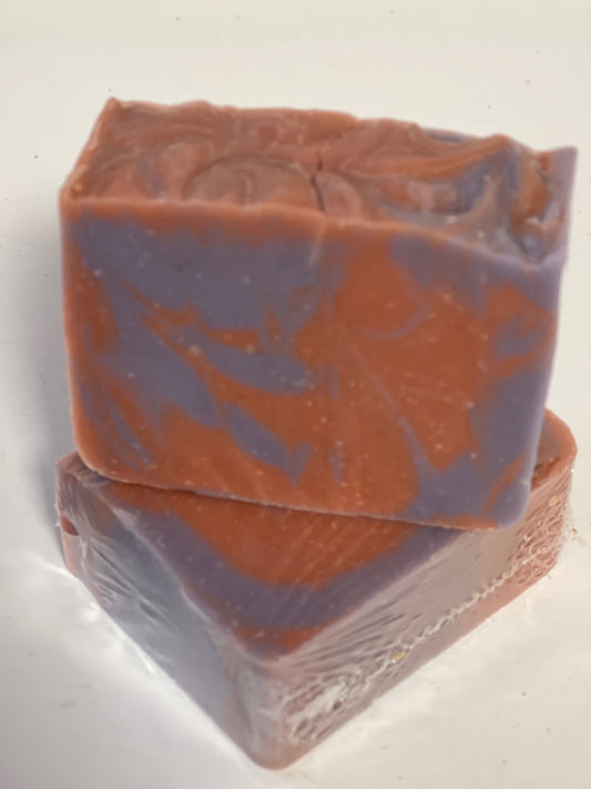 Photo of light blue and pink colored soap with fresh sugared berries sent