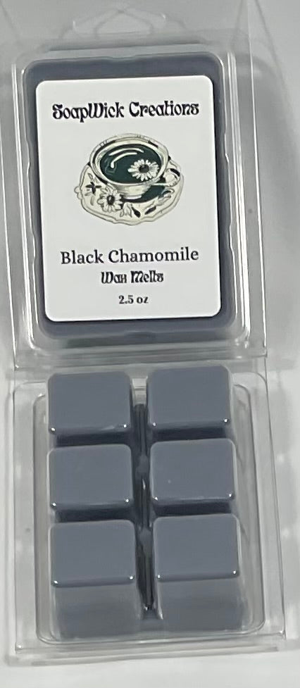 Photograph of black colored wax melts with black chamomile tea scent.