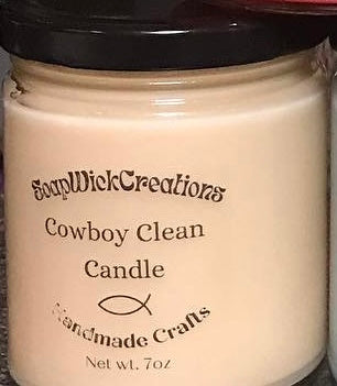 Photograph of a beige candle in a jar with cedar leather scent, titled “Cowboy Clean”