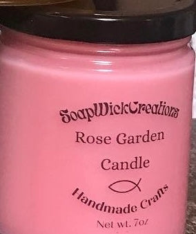 Photograph of a pink colored candle with rose scent
