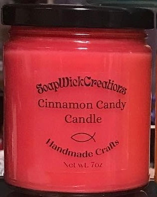 Photograph of a red candle in a jar with cinnamon candy scent