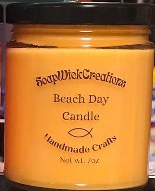 Photograph of a orange in color candle with beach scents of coconut and mango